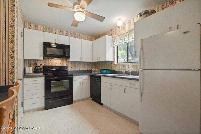 kitchen featuring light floors, dark countertops, a sink, and black appliances