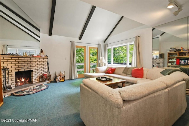 living area featuring vaulted ceiling with beams, a brick fireplace, and carpet flooring