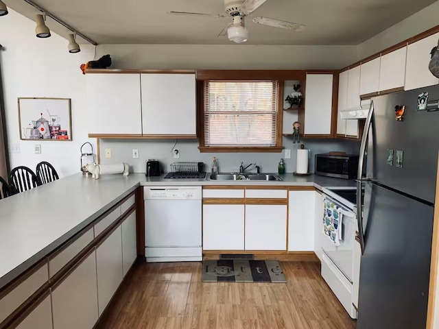 251 Dorchester Dr, Bushkill, PA 18324 - kitchen with stainless steel appliances, track lighting, wood finished floors, and white cabinets