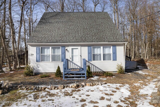 cape cod home with roof with shingles and crawl space