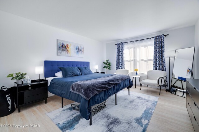 bedroom featuring light wood-style flooring