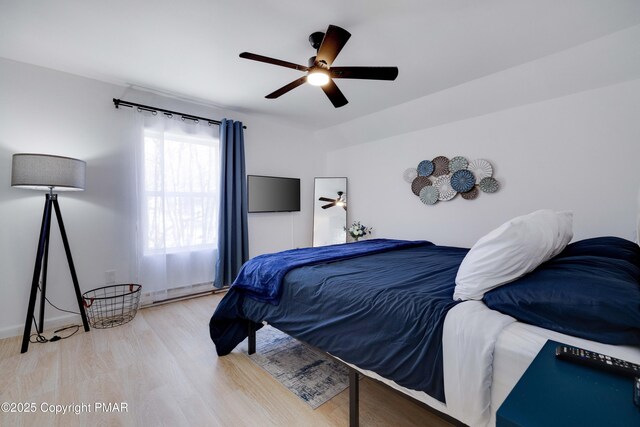 bedroom with ceiling fan and wood finished floors