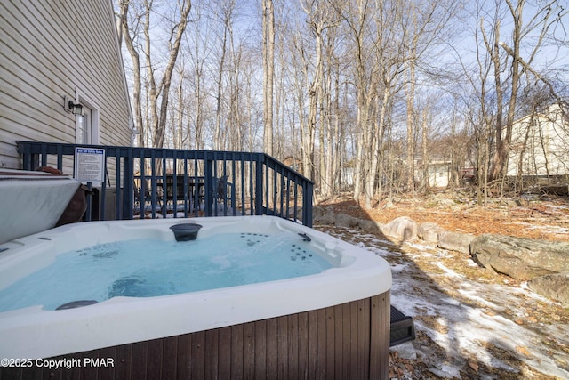 snow covered deck featuring a hot tub