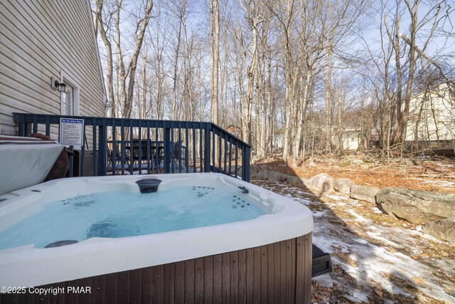 wooden deck featuring a hot tub