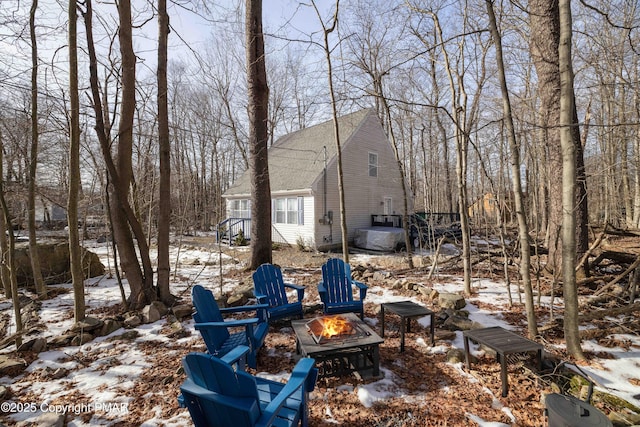 snowy yard featuring a fire pit