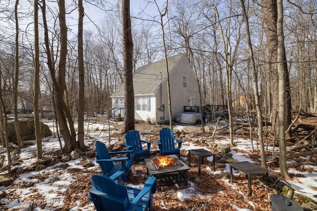 yard layered in snow with a fire pit