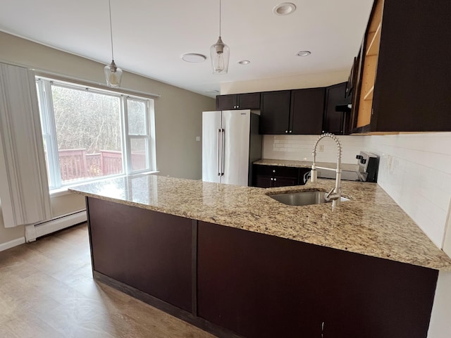 211 Beaver Dam Rd, Long Pond, PA 18334 - kitchen featuring stainless steel appliances, a baseboard radiator, a sink, a peninsula, and backsplash