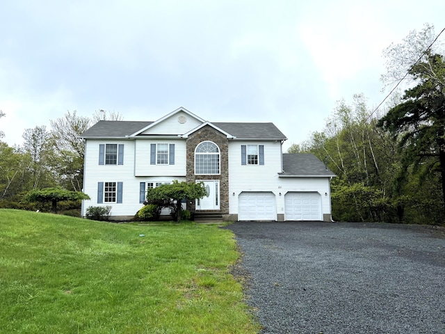 211 Beaver Dam Rd, Long Pond, PA 18334 - view of front of house with asphalt driveway, a front lawn, an attached garage, and a shingled roof