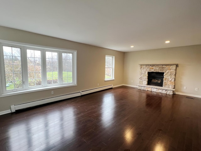 211 Beaver Dam Rd, Long Pond, PA 18334 - unfurnished living room with a baseboard heating unit, wood finished floors, a stone fireplace, recessed lighting, and baseboards
