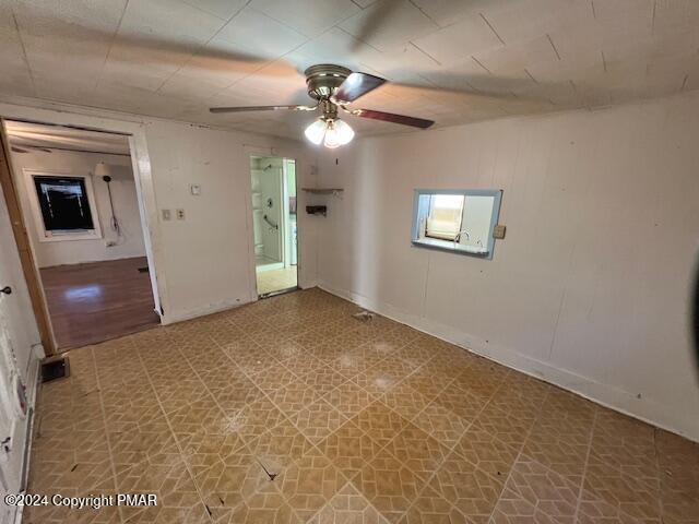 unfurnished room featuring a ceiling fan and tile patterned floors