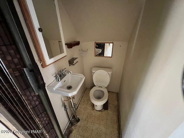 half bath with a sink and toilet