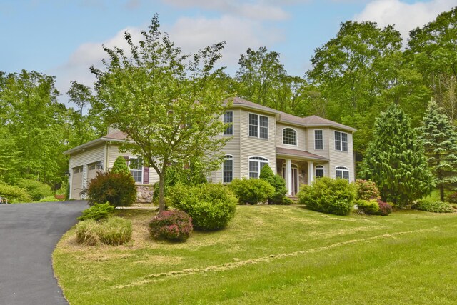 210 Edwin Ln, Stroudsburg, PA 18360 - view of front of property featuring a front yard, asphalt driveway, and a garage