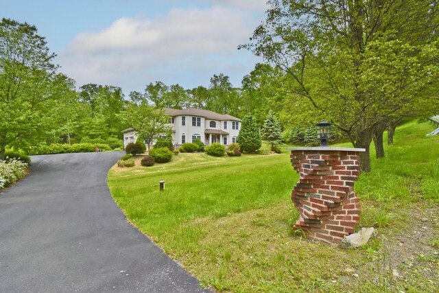 210 Edwin Ln, Stroudsburg, PA 18360 - colonial house featuring an attached garage, a front yard, and driveway