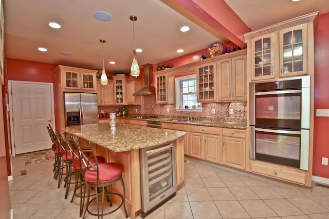 210 Edwin Ln, Stroudsburg, PA 18360 - kitchen featuring appliances with stainless steel finishes, beverage cooler, wall chimney exhaust hood, tasteful backsplash, and a kitchen bar