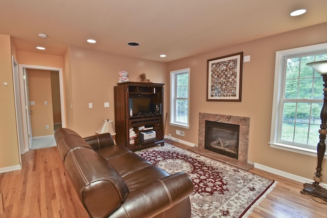 210 Edwin Ln, Stroudsburg, PA 18360 - living room with plenty of natural light, light wood-type flooring, a high end fireplace, baseboards, and recessed lighting