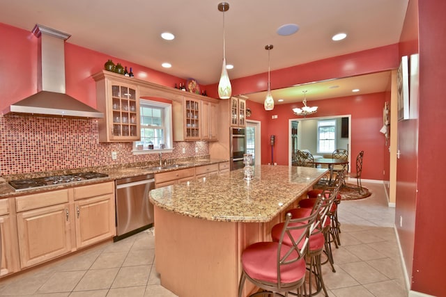 210 Edwin Ln, Stroudsburg, PA 18360 - kitchen with wall chimney exhaust hood, appliances with stainless steel finishes, light tile patterned floors, a kitchen island, and light stone counters
