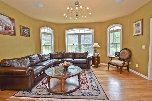 210 Edwin Ln, Stroudsburg, PA 18360 - living area with a chandelier, plenty of natural light, light wood finished floors, and baseboards