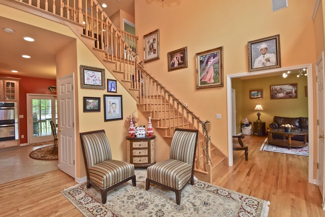 210 Edwin Ln, Stroudsburg, PA 18360 - living area featuring stairway, baseboards, wood finished floors, recessed lighting, and a high ceiling