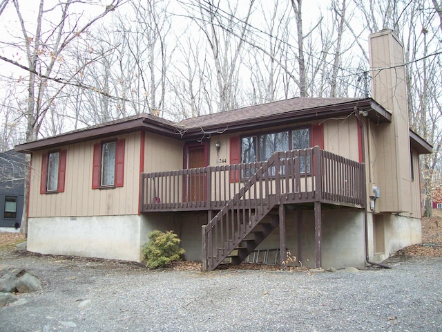 view of front of house with stairs, roof with shingles, crawl space, and a chimney