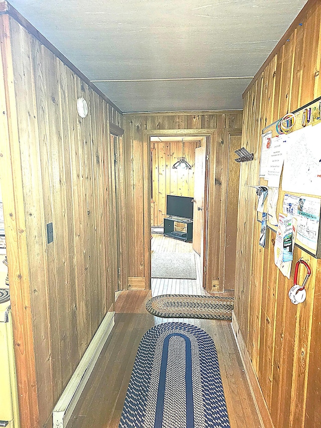 hallway featuring hardwood / wood-style floors and wooden walls