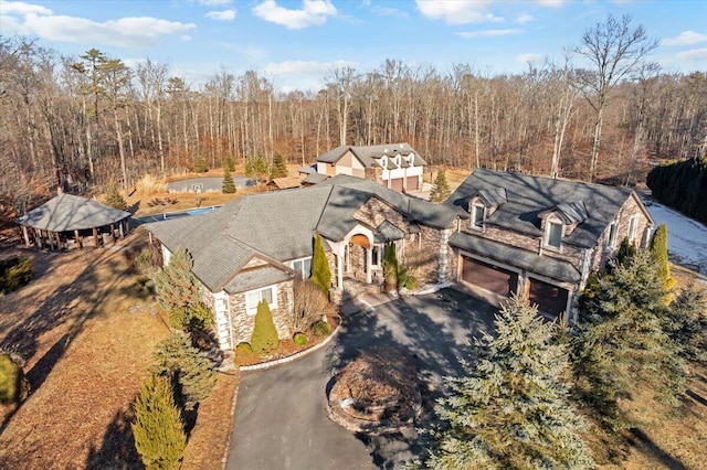 birds eye view of property with a view of trees