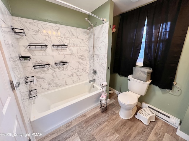 full bath with a baseboard heating unit, toilet, shower / washtub combination, and wood finished floors