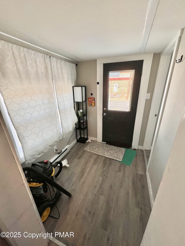 foyer with wood finished floors and baseboards