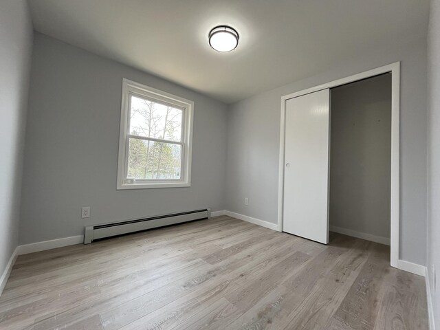 3015 Mountain Ter, Stroudsburg, PA 18360 - unfurnished bedroom featuring baseboard heating, light wood-style floors, and a closet