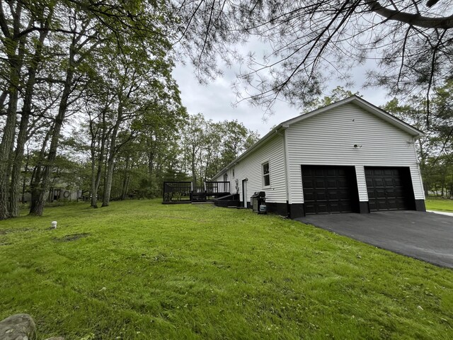 3015 Mountain Ter, Stroudsburg, PA 18360 - view of property exterior featuring driveway, a wooden deck, a lawn, and a garage