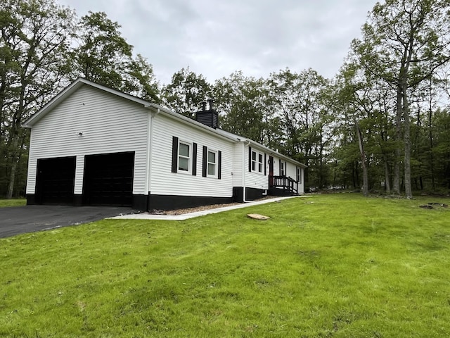3015 Mountain Ter, Stroudsburg, PA 18360 - view of property exterior featuring a chimney, driveway, a yard, and an attached garage