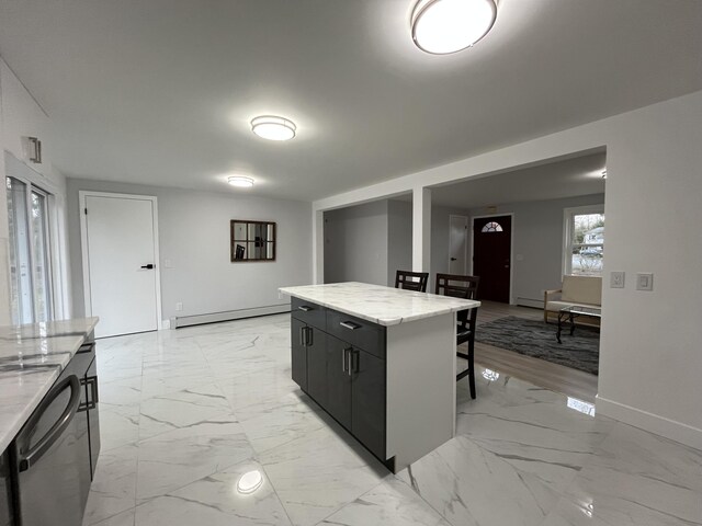 3015 Mountain Ter, Stroudsburg, PA 18360 - kitchen with baseboard heating, a kitchen bar, dishwashing machine, a kitchen island, and light marble finish floors