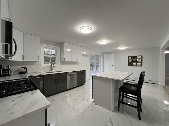 3015 Mountain Ter, Stroudsburg, PA 18360 - kitchen with black appliances, backsplash, a breakfast bar, and healthy amount of natural light