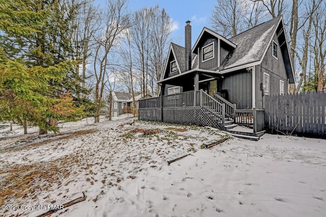 snow covered property featuring a porch