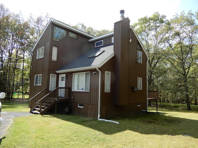 124 Segatti Cir, Bushkill, PA 18324 - view of front of house with a chimney, roof with shingles, and a front lawn