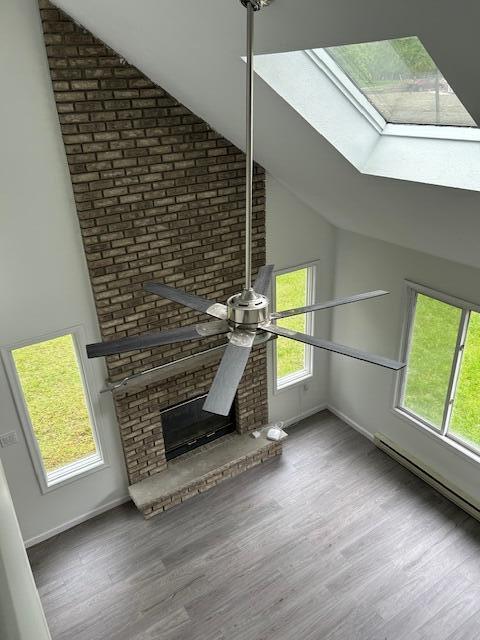 124 Segatti Cir, Bushkill, PA 18324 - detailed view of a ceiling fan, wood finished floors, a skylight, and baseboards