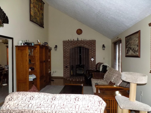 interior space featuring lofted ceiling, a wood stove, hardwood / wood-style floors, and a textured ceiling