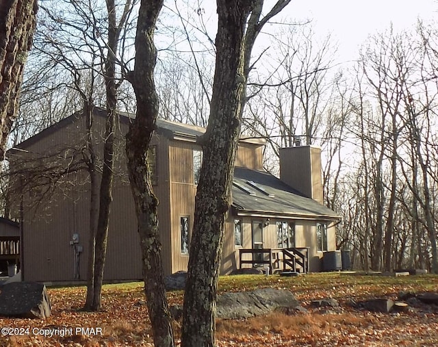 view of side of home featuring a chimney