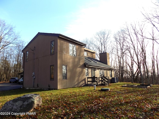 view of home's exterior featuring central AC unit and a yard