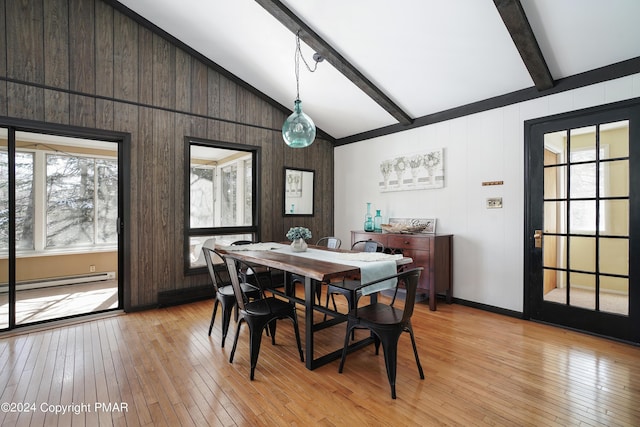 dining space with a wealth of natural light, vaulted ceiling with beams, and light wood-style flooring