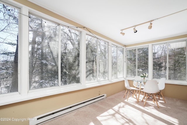 unfurnished sunroom with a baseboard radiator and track lighting