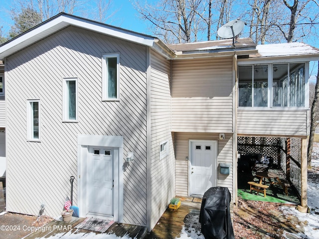 back of house with a sunroom