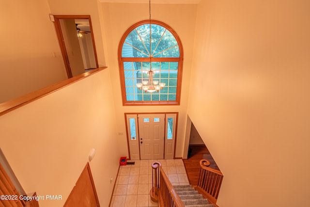 foyer with light tile patterned floors and a chandelier