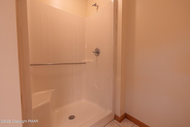 bathroom with tile patterned floors and walk in shower