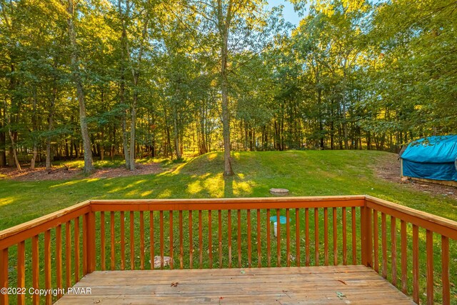 wooden deck with a lawn