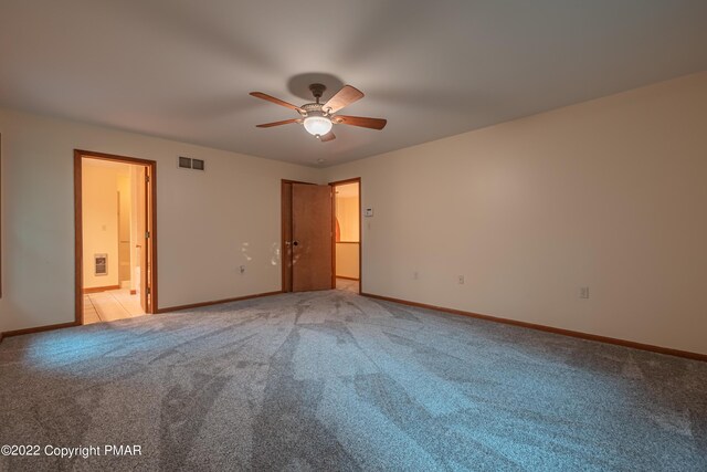 unfurnished bedroom with light colored carpet and ceiling fan