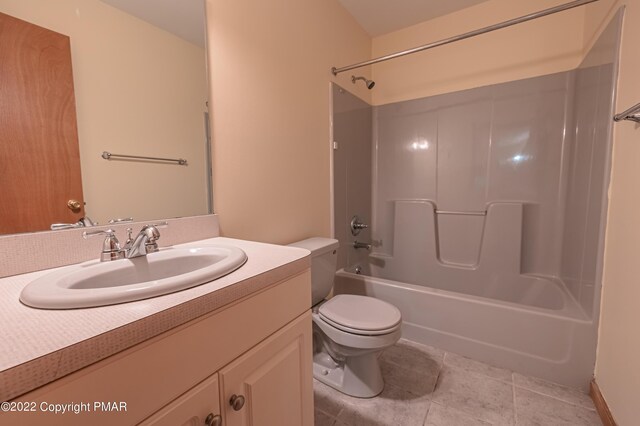 full bathroom with tile patterned floors, shower / washtub combination, toilet, and vanity