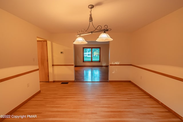 unfurnished dining area with light hardwood / wood-style flooring