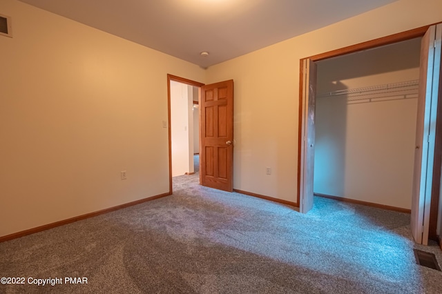 unfurnished bedroom featuring a closet and carpet flooring