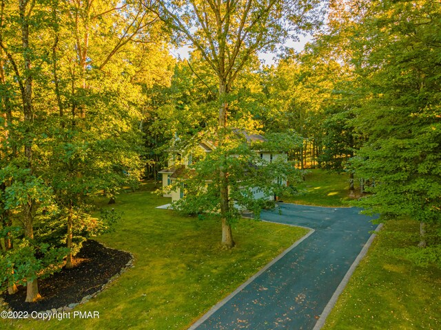 view of home's exterior featuring a garage and a lawn