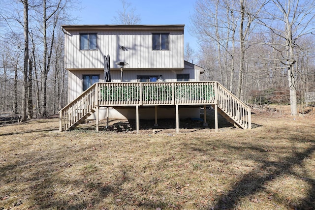 rear view of property featuring stairway and a deck